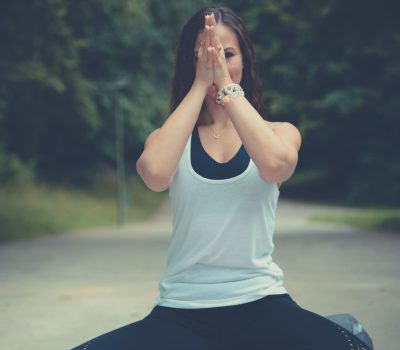 Frau sitze in Meditation auf Straße